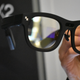 A pair of glasses with small camera displays on both sides.